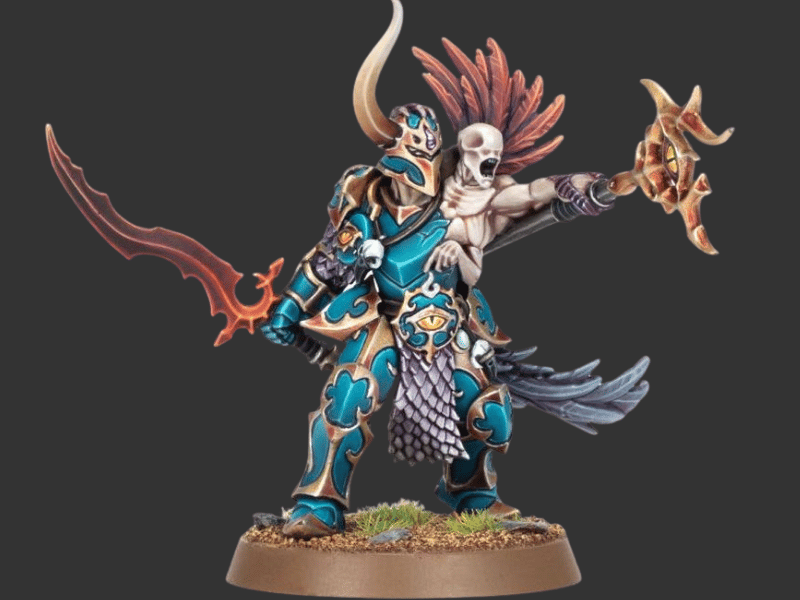A painted fantasy miniature figurine of a horned warrior in ornate blue armor with gold detailing, holding a curved orange-red sword, standing on a round base against a dark gray background.