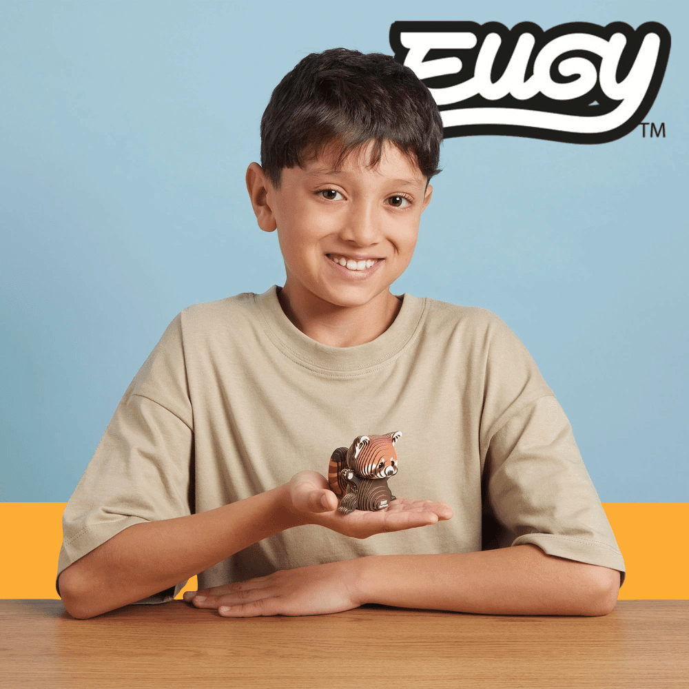 A child showing off a completed eugy 3d animal