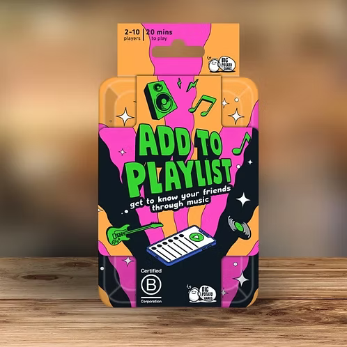 Add to Playlist Travel game tin standing on a wooden table