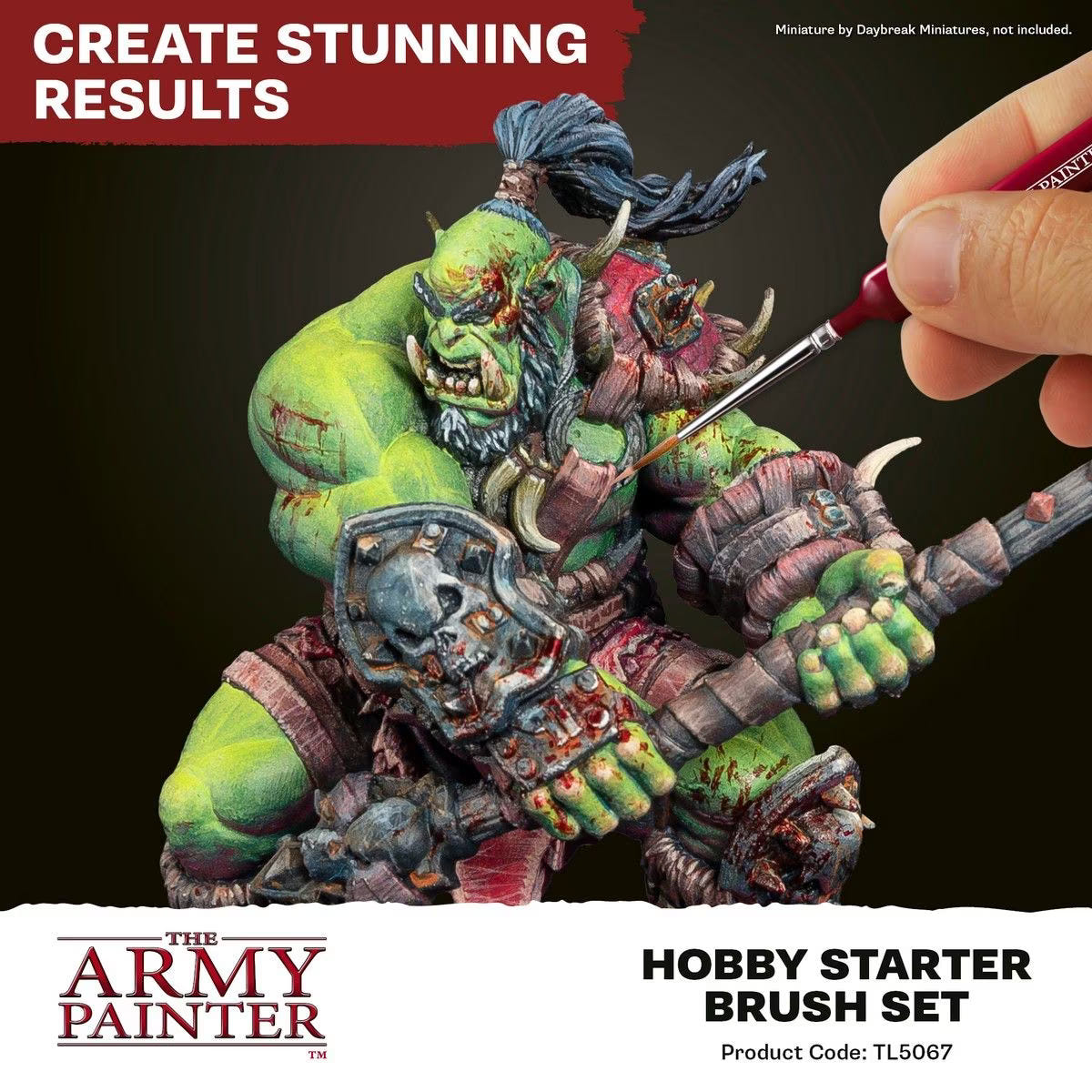 Army Painter brush highlighting a painted green orc miniature, from the Hobby Starter Brush Set