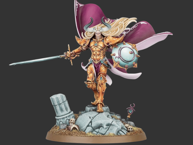 A painted fantasy warrior miniature figurine standing on a rocky base, holding a sword and a glowing orb, with flowing purple and white fabric behind it, photographed against a dark gray background.