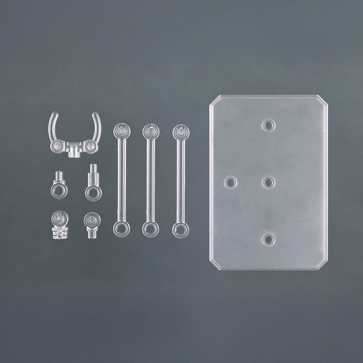 Bandai Action Base 6 Clear parts laid out: base plate, arm sections and holder clips