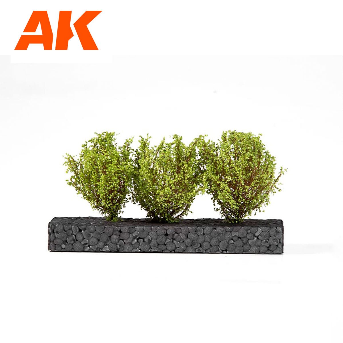 AK Interactive light green 4-6cm diorama bushes shown planted on a black display strip