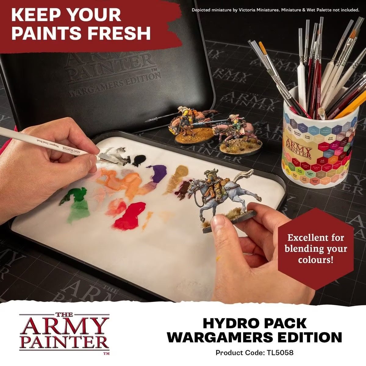 Painter mixing paint on an Army Painter wet palette fitted with a Hydro Pack sheet