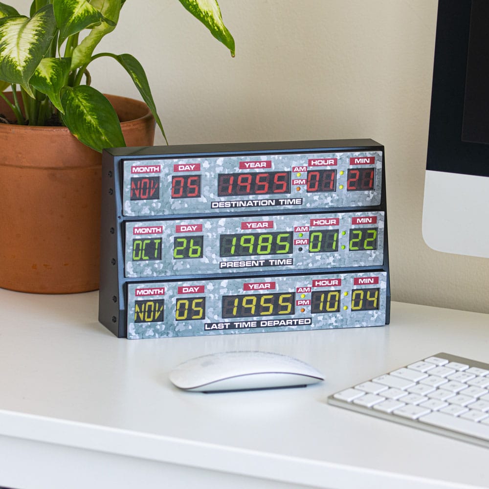 Back To The Future time circuits light on a desk beside a keyboard and pot plant