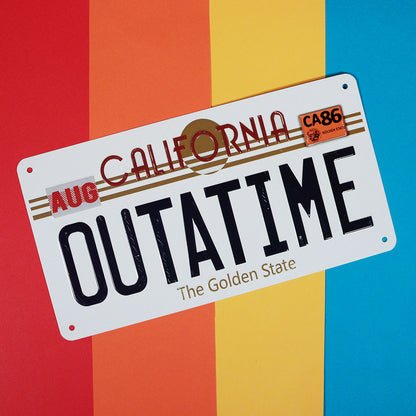 Back to the Future OUTATIME tin sign shown at an angle on a red, orange, yellow and blue backdrop