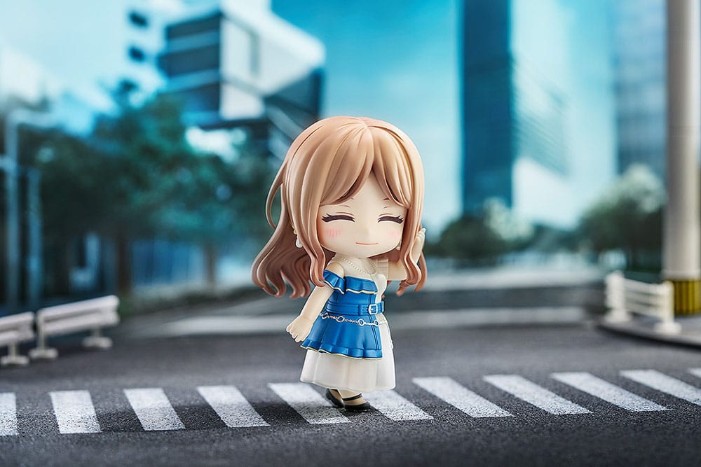Soyo Nagasaki Nendoroid smiling on a zebra crossing in a daytime street scene