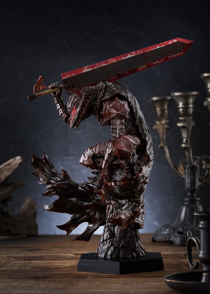 Berserk Pop Up Parade L Guts Bloody Paint Ver. on a wooden table with candlesticks