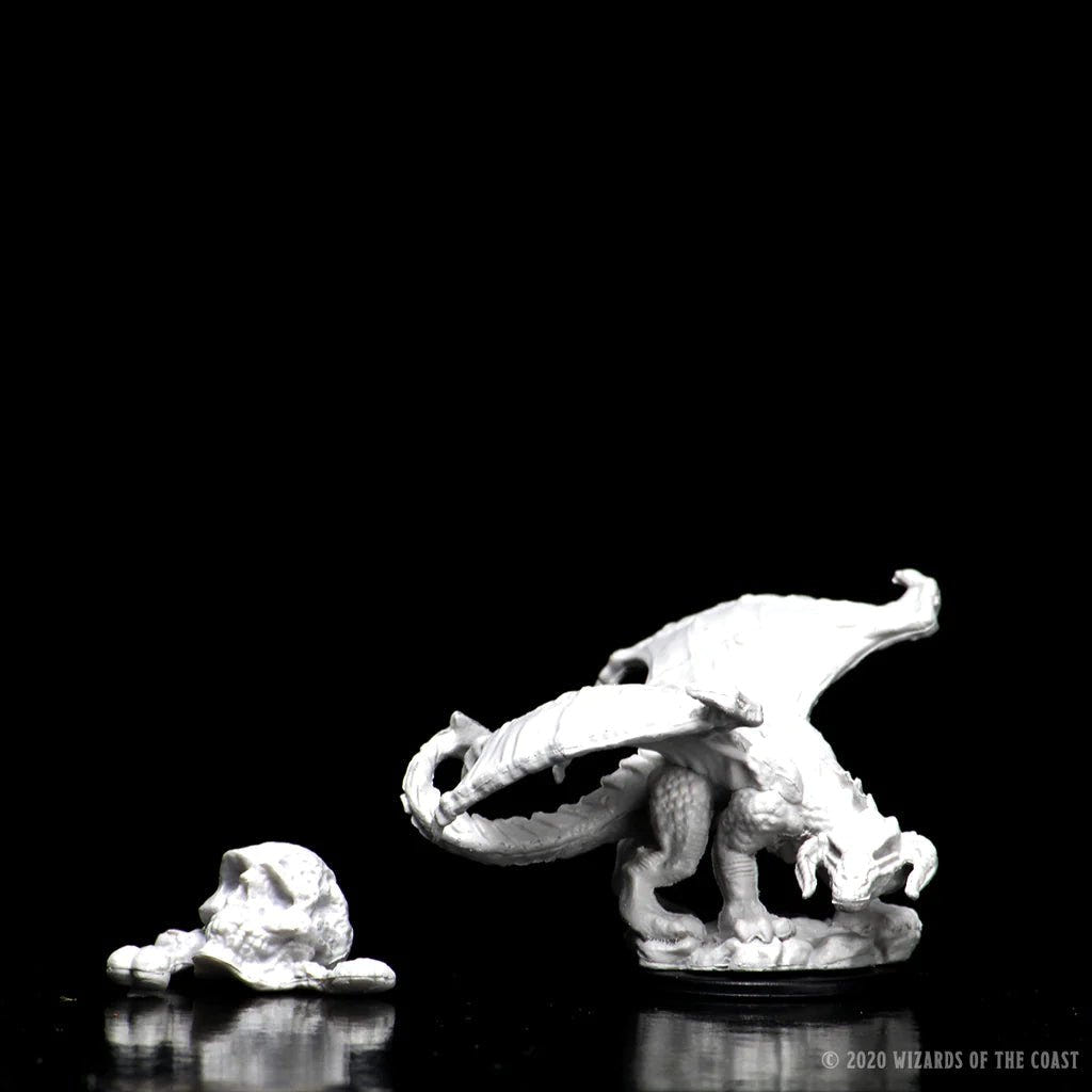 Unpainted Black Dragon Wyrmling miniature with the giant skull terrain piece, on black