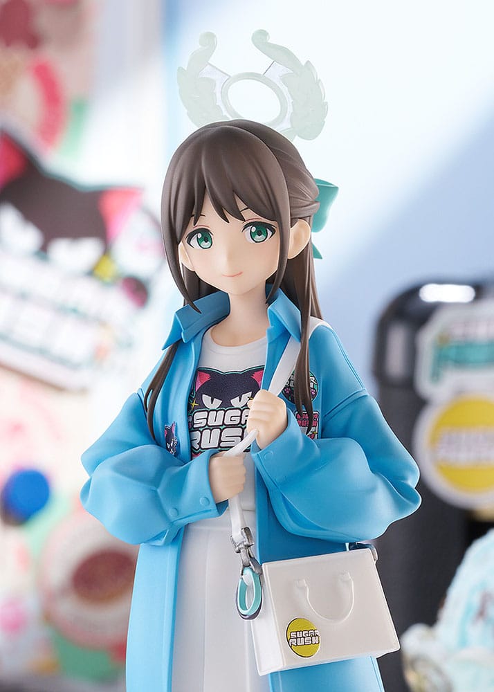Close-up of Airi figure's smiling face, halo and blue jacket, sweets shop backdrop