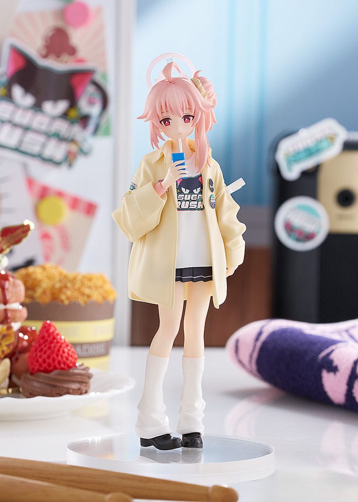 Pop Up Parade Natsu figure on clear base beside cakes in a sweets shop setting
