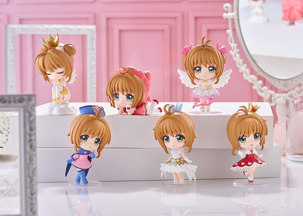 Six Sakura Kinomoto mini figures from the Clear Card blind box range on a pink dressing table