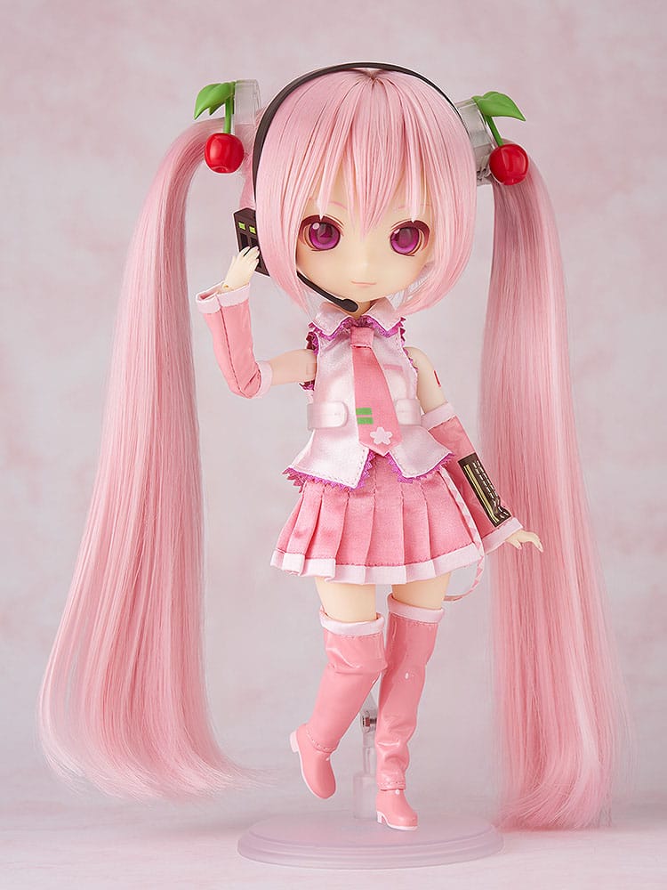 Sakura Miku Harmonia humming doll touching her headset microphone, one leg raised