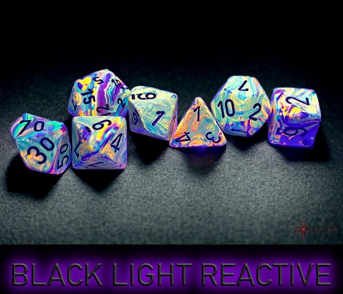 Chessex Festive Vibrant dice glowing under black light, seven-piece set