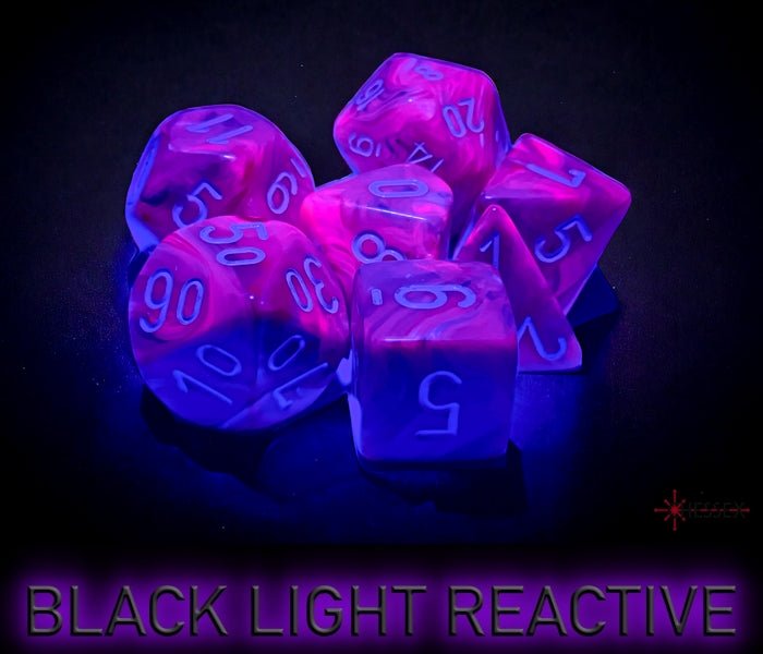 Chessex Festive Violet dice glowing under black light, showing the UV-reactive effect