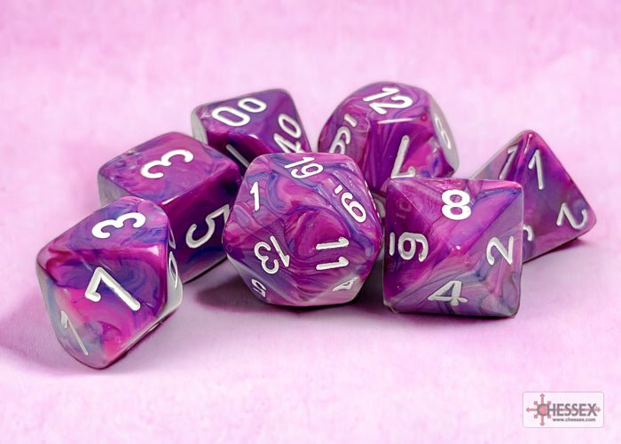 Chessex Festive Violet with White dice grouped on a soft pink background