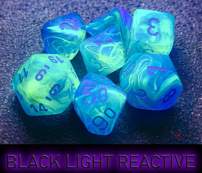 Chessex Festive Waterlily dice glowing under black light, showing the reactive finish