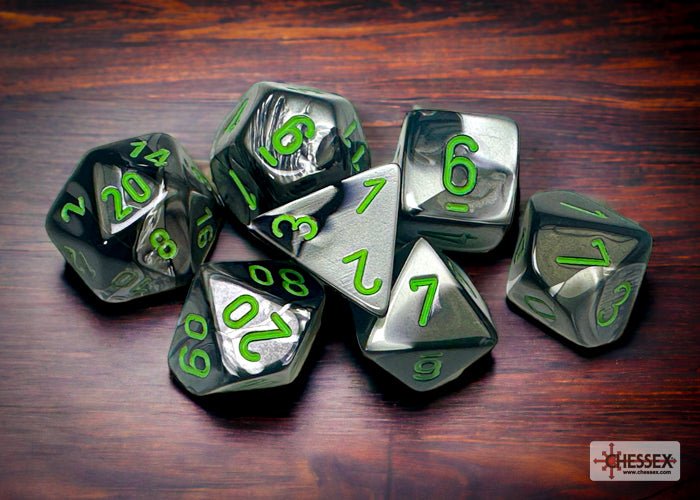 Chessex Gemini Black-Grey with Green polyhedral dice scattered on a wooden table