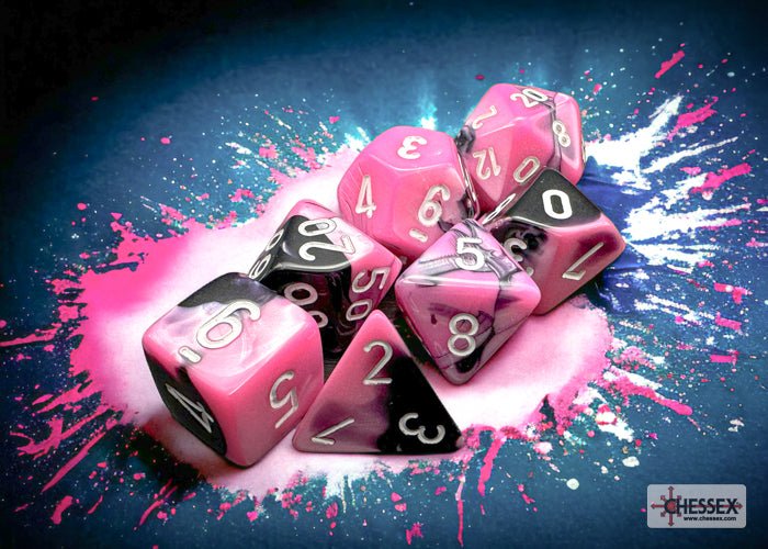 Chessex Gemini Black-Pink polyhedral dice on a pink and white paint-splash background