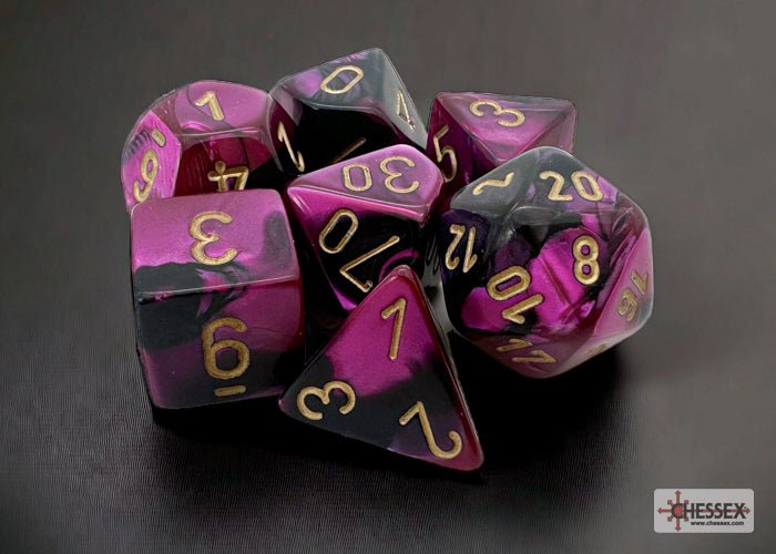 Chessex Gemini Black-Purple with Gold 7 dice set grouped on a dark background