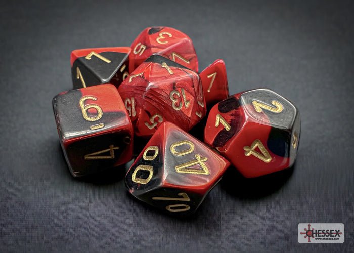 Chessex Gemini Black-Red with Gold dice on a dark grey backdrop