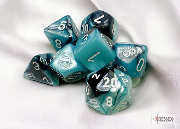 Chessex Gemini Black-Shell swirled dice set on a soft white cloth