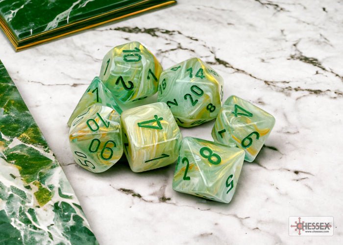 Chessex Marble Green seven-dice set on a marble tabletop, showing the green numbering