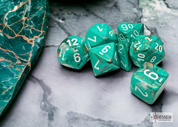 Chessex Marble Oxi-Copper seven dice set on a marble surface