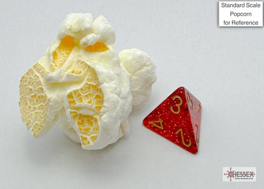 Chessex Mini Glitter Ruby Gold d4 beside a piece of popcorn to show its small scale