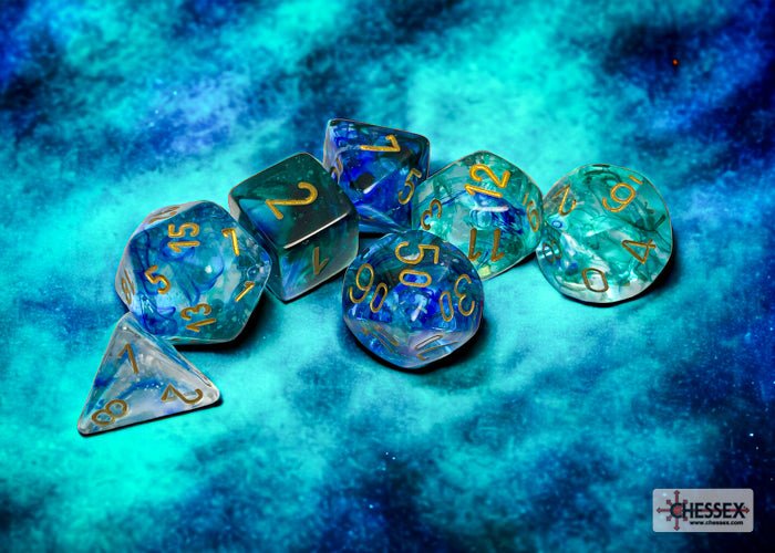 Chessex Nebula Oceanic Gold seven-dice set on a blue cosmic backdrop