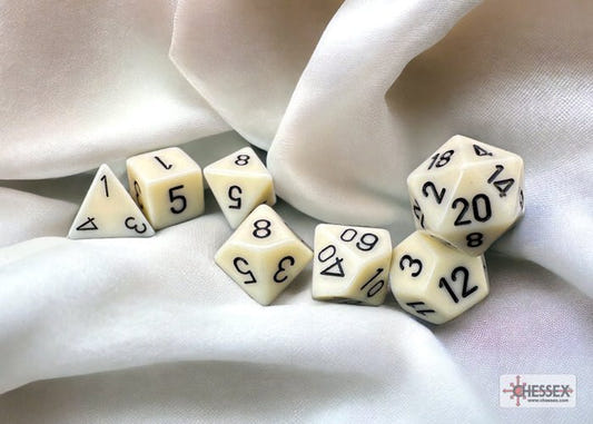 Chessex Opaque Ivory with Black polyhedral dice on draped cream fabric
