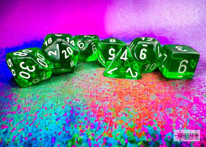 Chessex Translucent Green and White dice lined up on a colourful speckled backdrop
