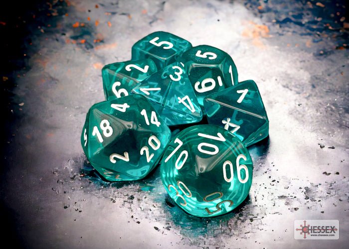 Chessex translucent teal dice with white numbers on a stone background
