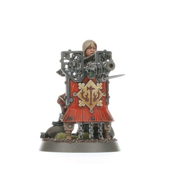 Painted Freeguild Fusilier aiming a long gun from behind a red pavise shield
