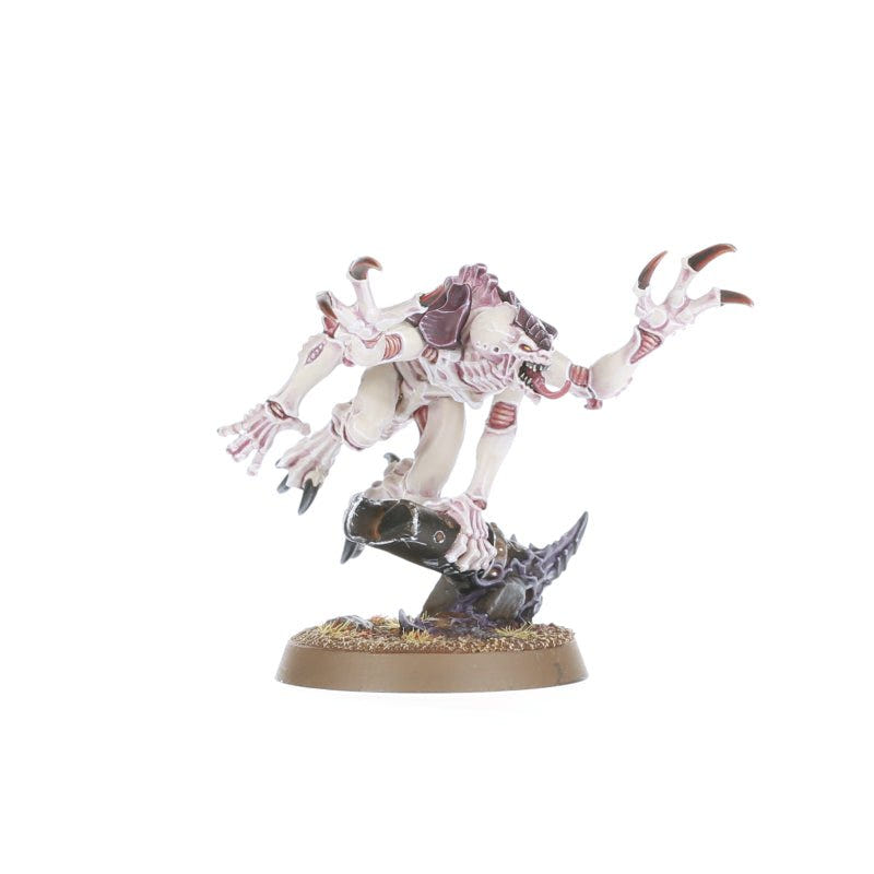 Painted Tyranid Genestealer crouched on rubble with claws outstretched