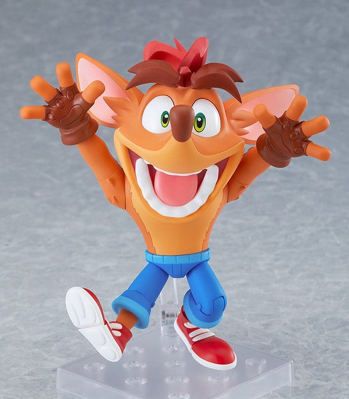 Crash Bandicoot Nendoroid on clear stand jumping with arms up and big toothy smile