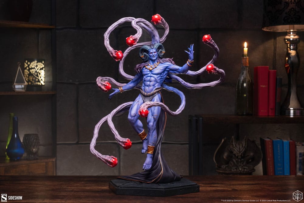 Critical Role Lucien the Neosomnovem statue displayed in a dark room beside books and candles