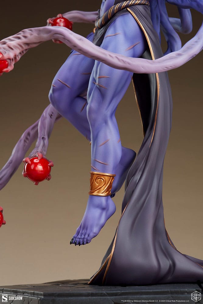 Close-up of Lucien's bare feet, gold anklet and flowing robe on the Critical Role statue