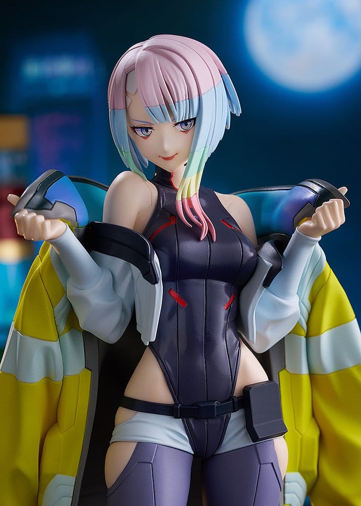 Close-up of Pop Up Parade Lucy figure face and yellow jacket against a neon city backdrop
