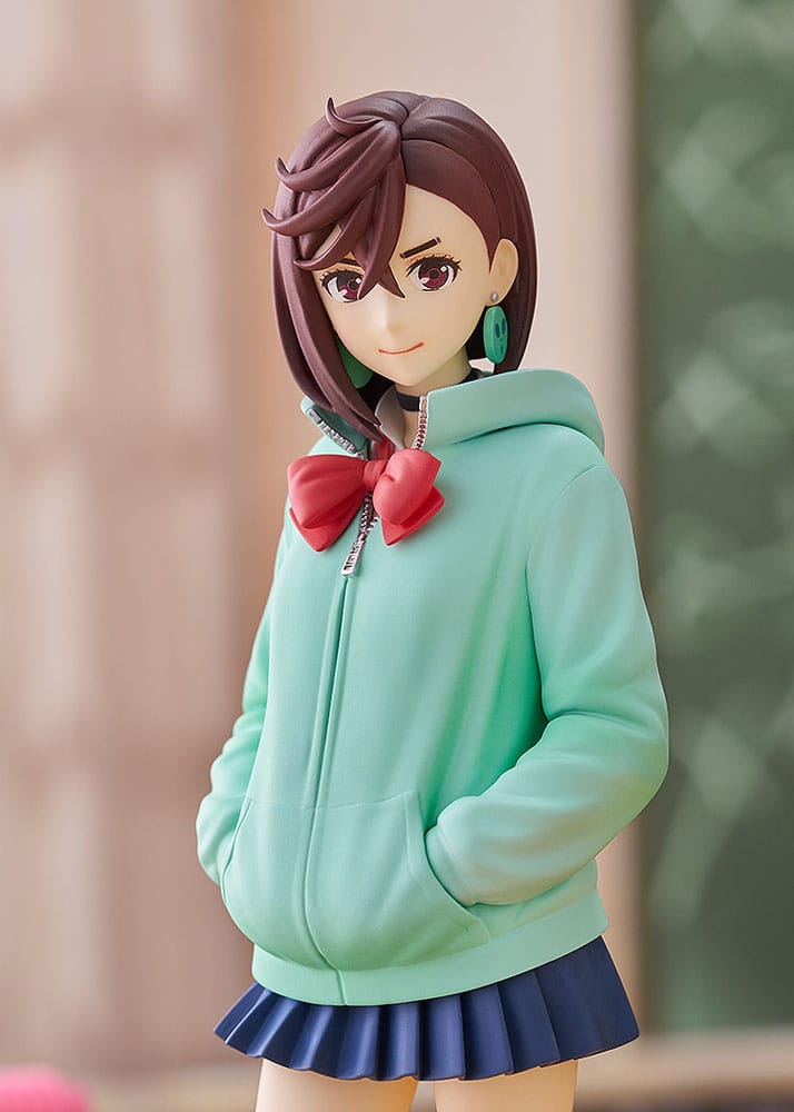 Close-up of Dandadan Momo figure's face, earrings and mint hoodie in a room setting