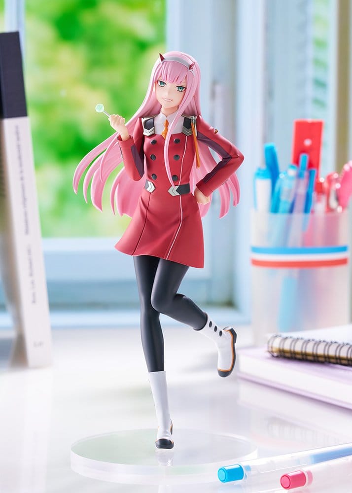Zero Two Pop Up Parade L figure displayed on a desk beside books and a pen pot