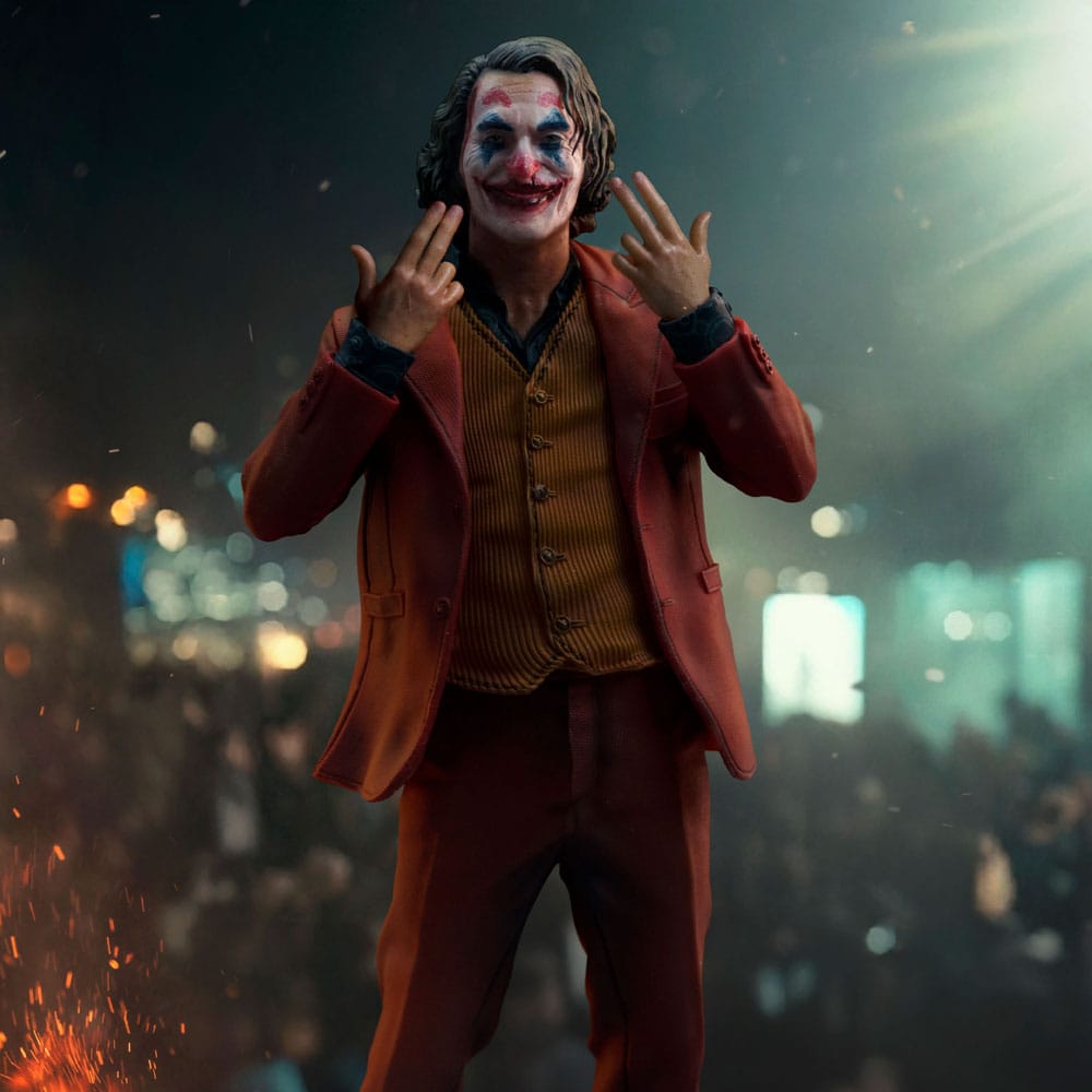 Iron Studios Joker Arthur Fleck statue pictured in a night-time street scene, forcing a smile