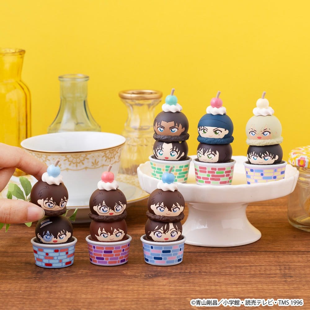 Hand stacking Detective Conan Tsumichen figures on a cake stand, lifestyle shot