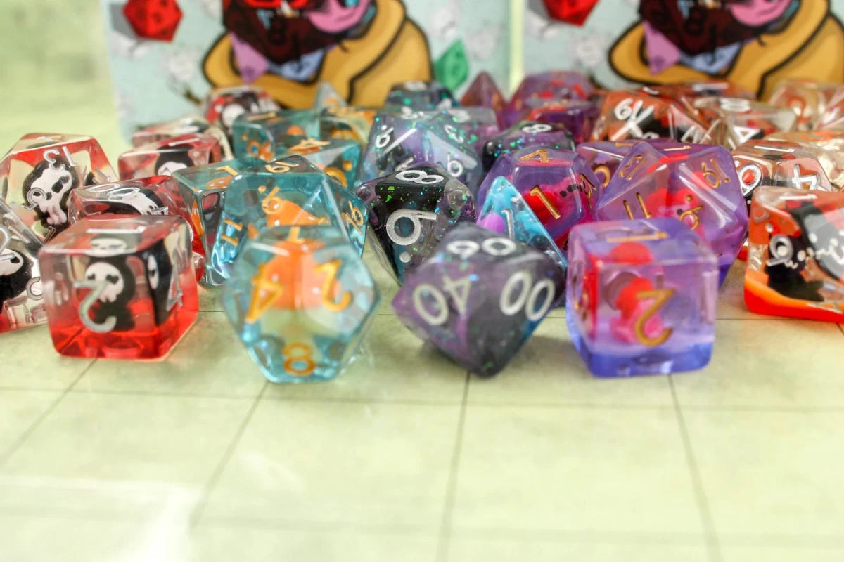 Close-up of colourful Dice Goblin filled RPG dice with inclusions, in front of the bag