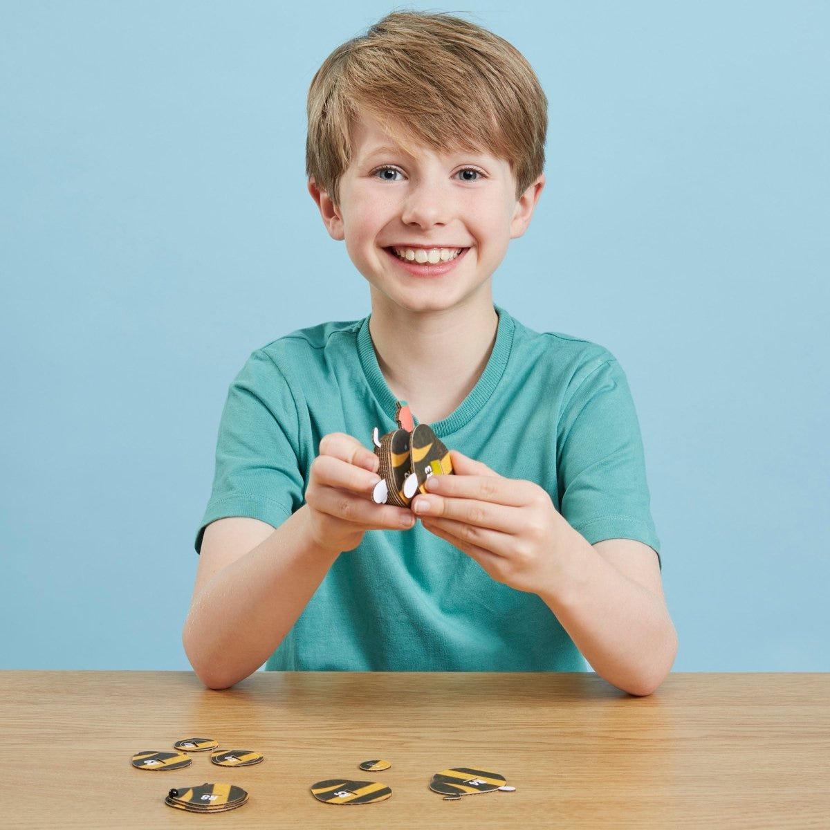 EUGY Bumblebee 3D cardboard model kit - child assembling the model
