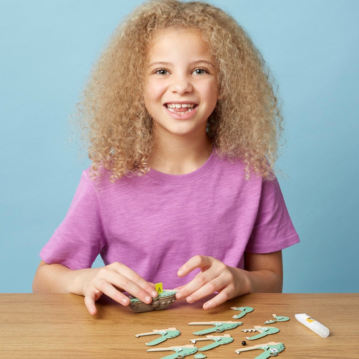 EUGY Crocodile 3D cardboard model kit - child assembling the model