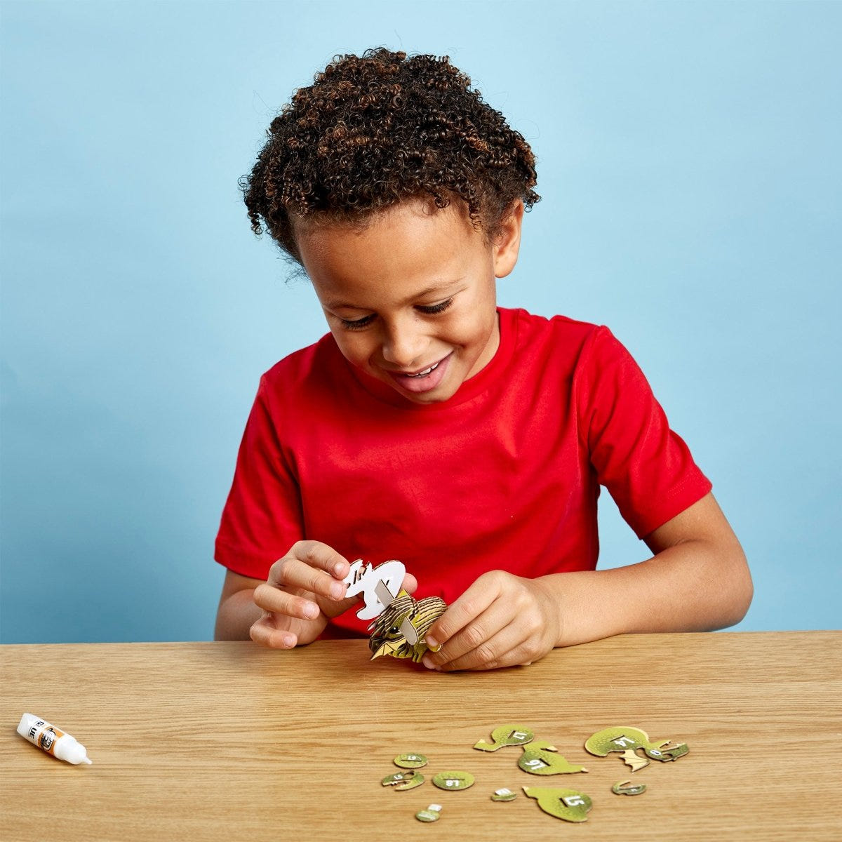 EUGY Dragon 3D cardboard model kit - child with the finished model