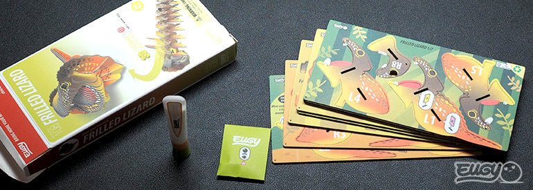 EUGY Frilled Lizard kit contents: box, pre-cut numbered card sheets and glue pot