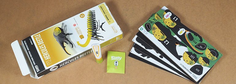 EUGY Hercules Beetle box opened with pre-cut card sheets and glue laid out