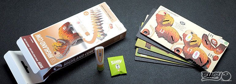 EUGY Highland Cow kit contents: box, card sheets, glue pot and instructions